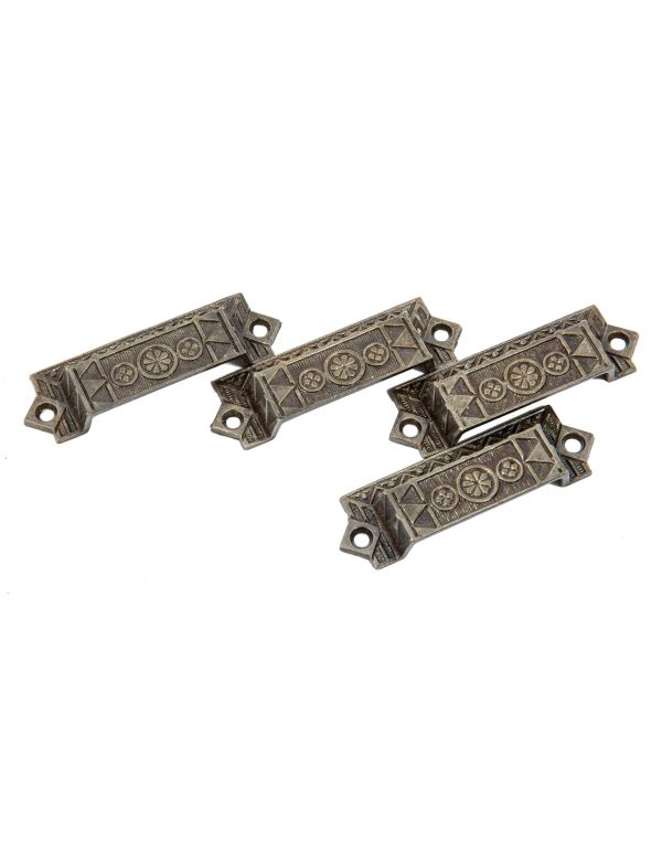 group of four matching original 1880s salvaged chicago ornamental cast iron drawer pulls handles with brushed metal finish