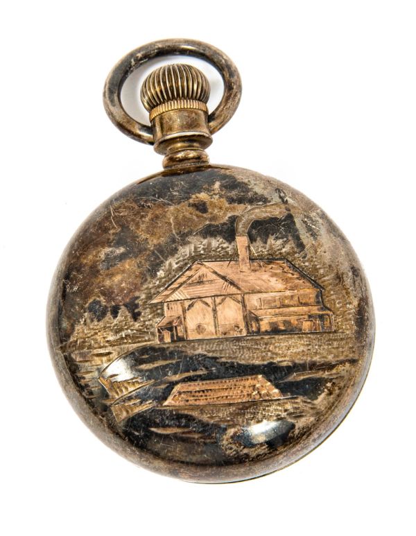 late 19th or early 20th century folk art pocket watch case with lighly incised cabin and river scene