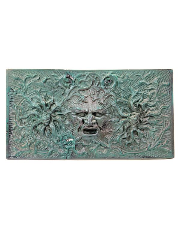 unusual painted green recast of a 19th century american victorian-era fireplace fireback with centrally located  "green man" 