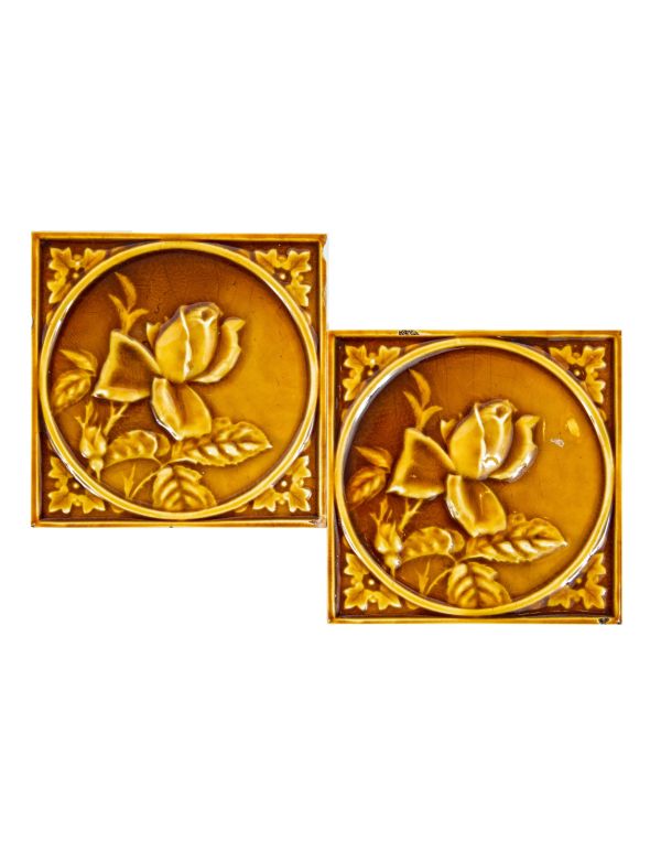 two matching 19th century butterscotch-colored encircled floral motif 6 x 6 fireplace mantel corner tiles
